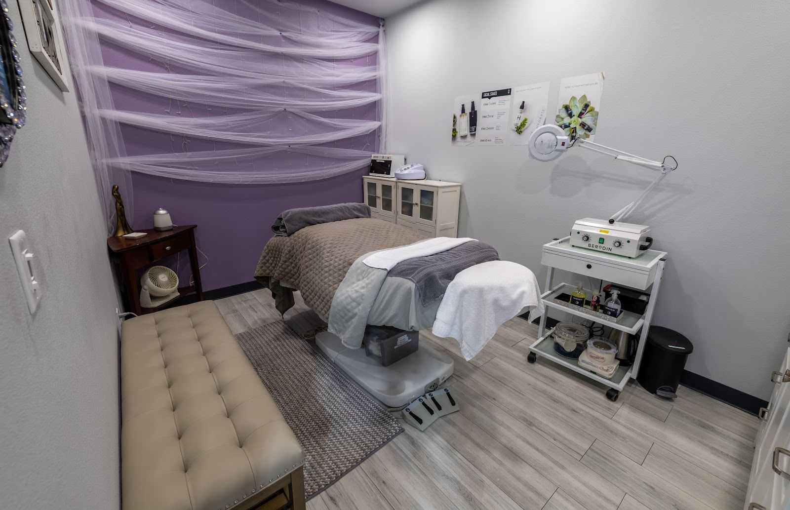 Cozy spa room with massage table, calming decor, and treatment equipment.