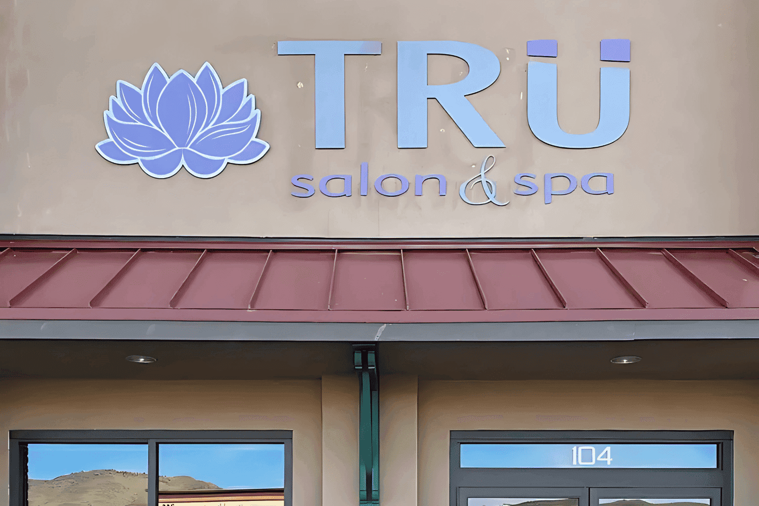 Exterior of TRU salon & spa entrance with logo above door.