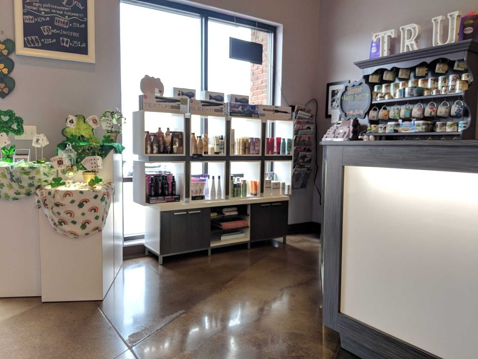 Hair salon interior with product shelves and reception desk. Bright and organized space.